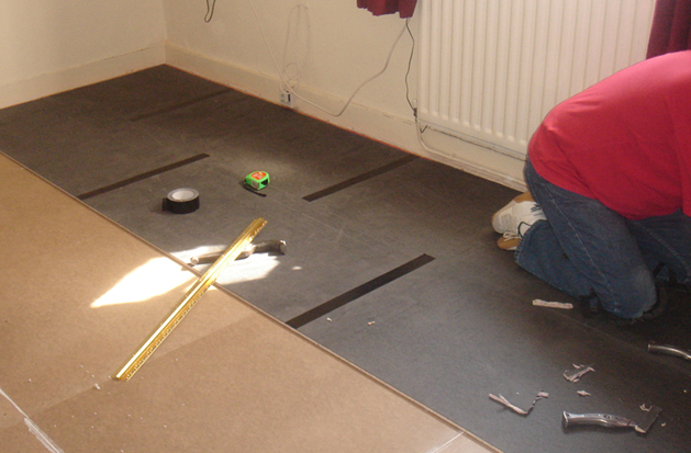 2.During.Acousticunderlaybeingputdown Gold Carpet Acoustic Underlay