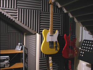 wedge profiled foam in a music practice room with guitars